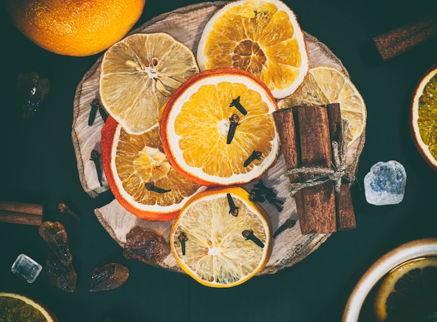 Slices of citrus fruits on a wooden surface 