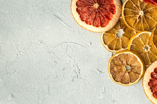 slices of citrus on gray texture background