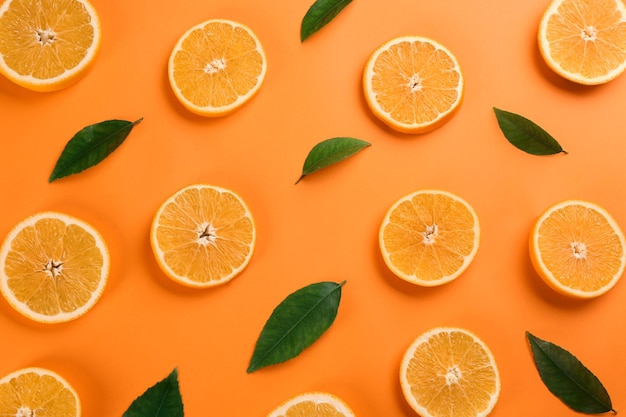 Slices of delicious oranges on color background flat lay