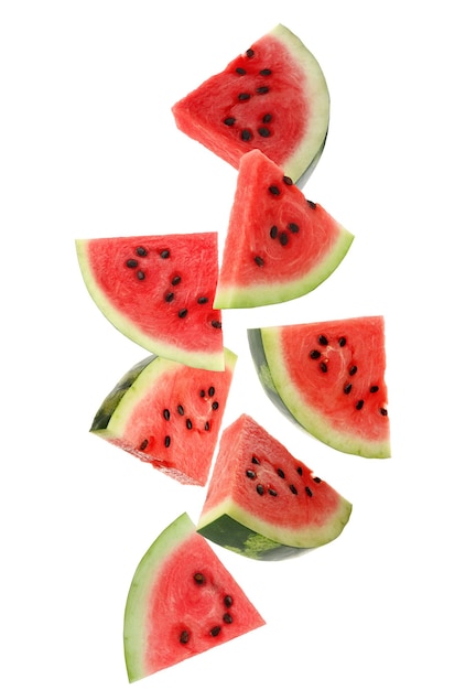 Slices of delicious ripe watermelon falling on white background