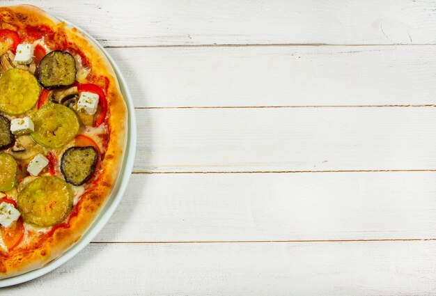 slices of different types of pizza on white background