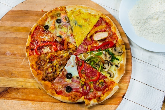 slices of different types of pizza on white background