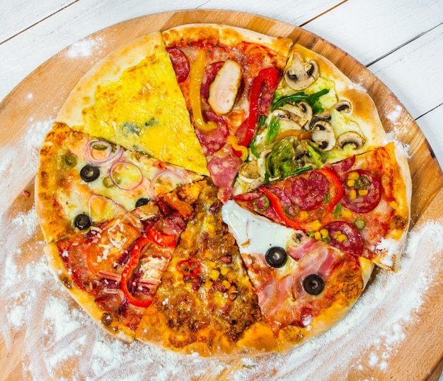 slices of different types of pizza on white background