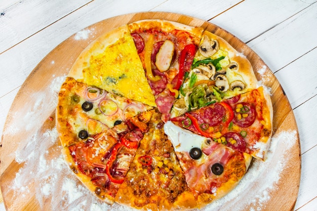 slices of different types of pizza on white background