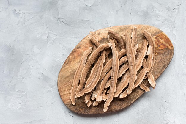 Slices of dried lingzhi mushroom also called Reishi on a wooden board