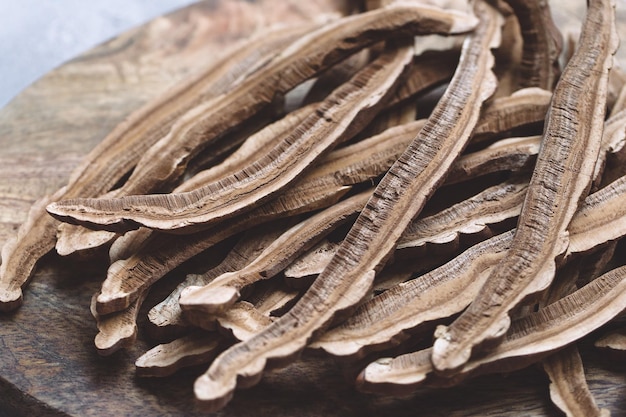 Slices of dried lingzhi mushroom also called Reishi on a wooden board