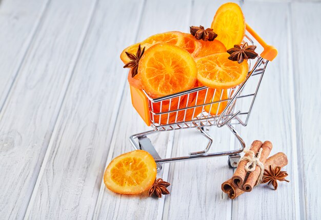 Slices of dried oranges or tangerines with anise and cinnamon in a supermarket cart. Vegetarianism and healthy eating.