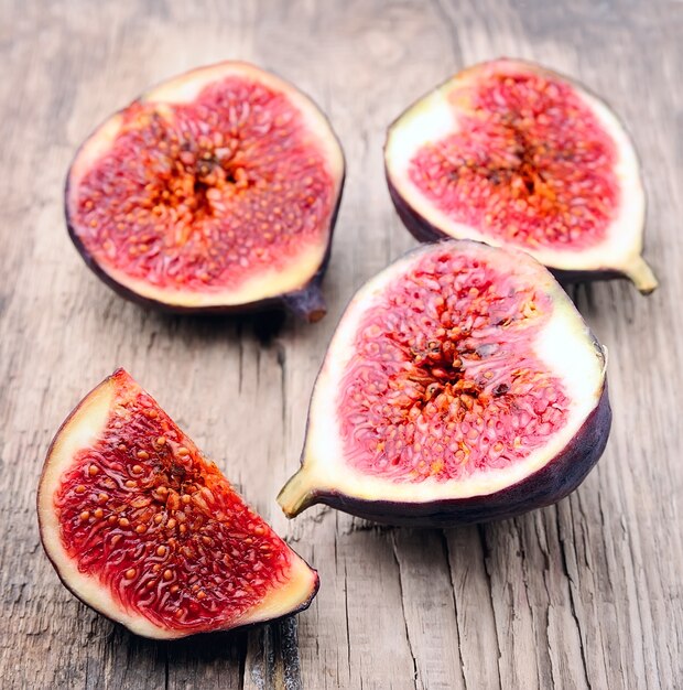 Slices of figs on wooden texture