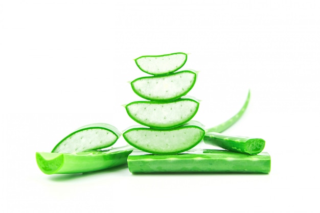 Slices of fresh aloe vera plant stacked and aloe vera stalk or leaves with water dropping isolate on white background.
