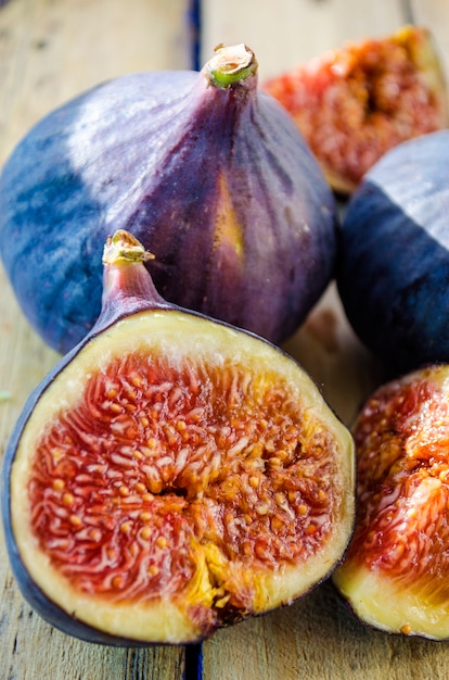 Slices of fresh figs on a wooden background