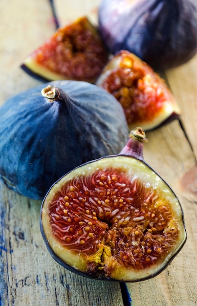 Slices of fresh figs on a wooden background