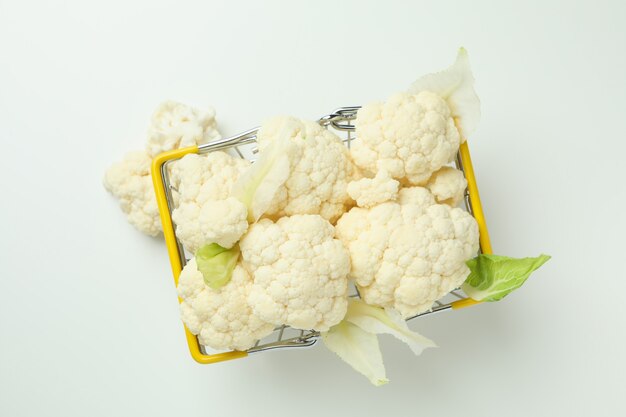 Slices of fresh juicy cauliflower in basket on white background