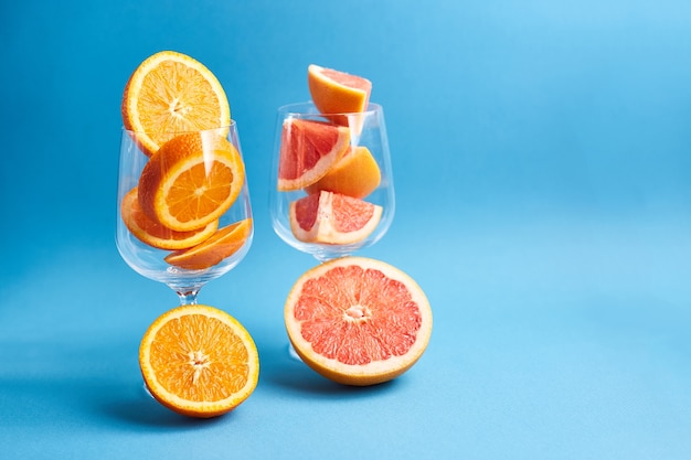 Slices of fresh orange and grapefruit in wineglass