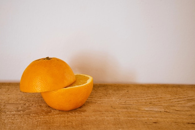 Slices of fresh organic orange on a wooden cutting board.