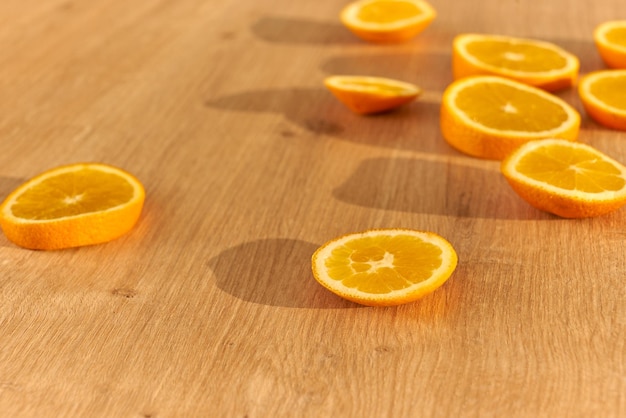 Slices of fresh organic oranges obn a wooden kitchen table.