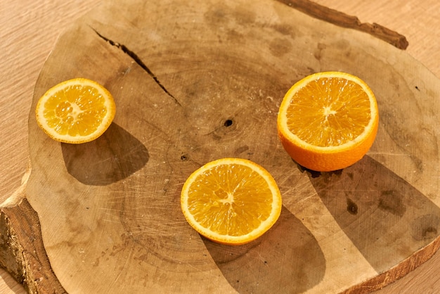 Slices of fresh organic oranges on a wooden kitchen table.