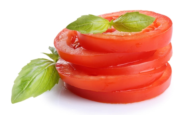 Slices of fresh tomato with basil isolated on white