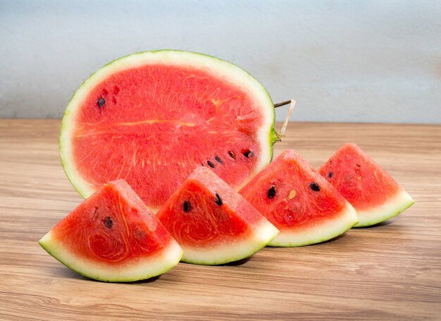 Slices of fresh watermelon on wood table