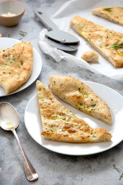 Slices of garlic foccacia bread. Freshly baked flat garlic bread with olive oil and herbs.