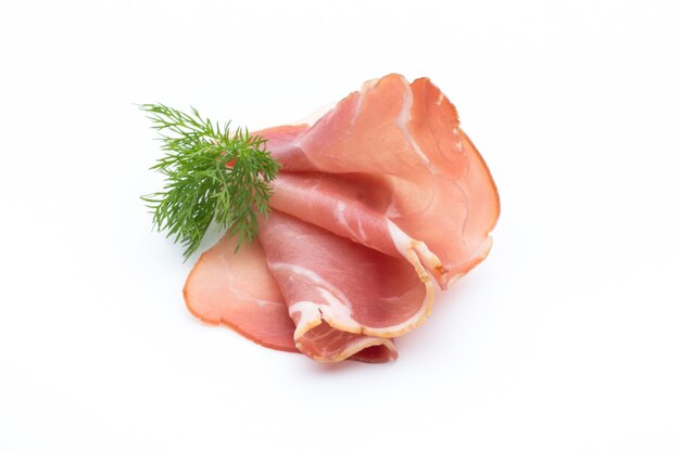 Slices of ham on white surface.