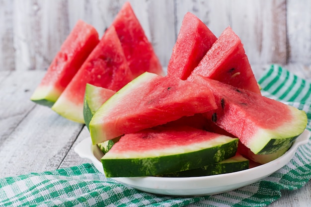 Slices of juicy and tasty watermelon on a white plate