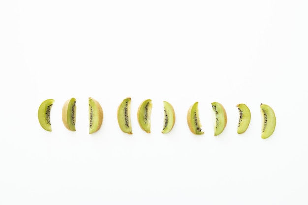 Slices of kiwi on white background