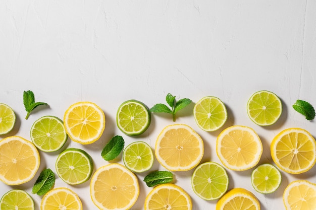 slices of lemon lime and mint leaves Summer food border flat lay