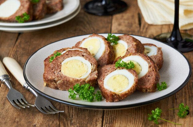 Slices of meatloaf with boiled eggs on a plate