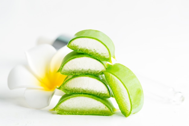 Slices of natural organic aloe vera plant for homemade cosmetic lotion or oil against white background.