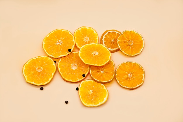 Slices of orange isolated on yellow or orange background top view