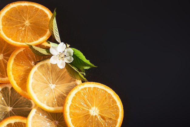 Slices of orange and lemon, isolated on a black.