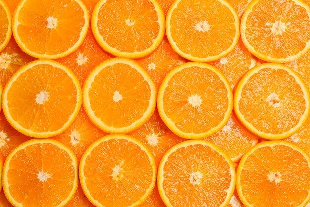 Slices of oranges as a background, top view.