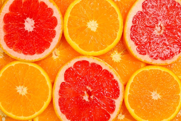 Slices of oranges and a grapefruits as a background