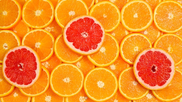 Slices of oranges and a grapefruits as a background.