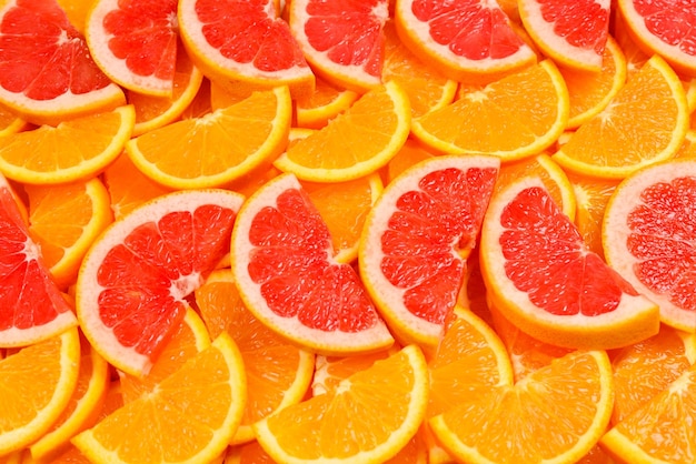 Slices of oranges and a grapefruits as a background