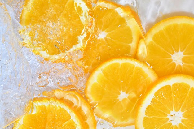 Slices of oranges in water on white background oranges close-up in liquid with bubbles slices