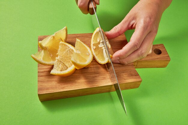 Slices of organic fresh yellow lemon on a wooden cutting board