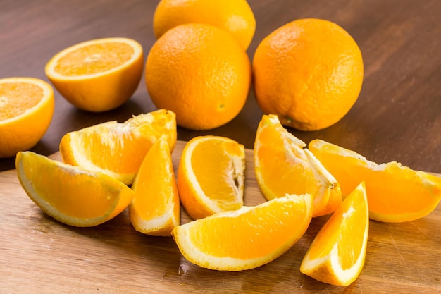 Slices of organic navel orange on cutting board.