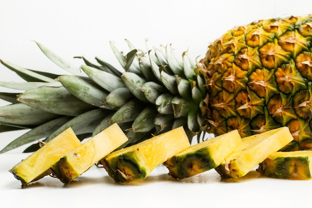 Slices of a pineapple on a white background