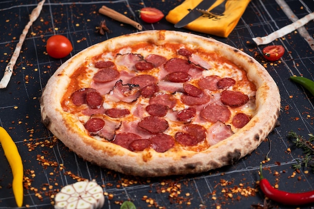 Slices of pizza on rustic wooden tray and dark background