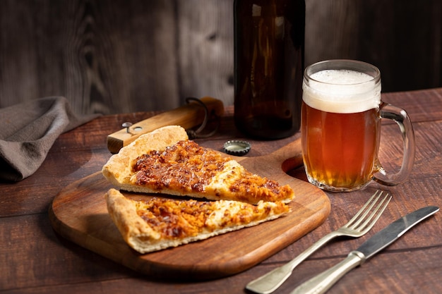 Slices of pizza with glass of beer on the table