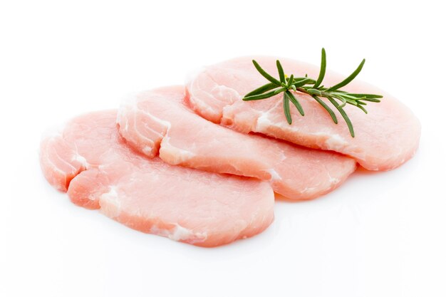 Slices of pork meat with rosemary isolated