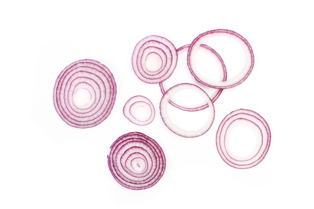 Photo slices of purple onion in a top view isolated on white