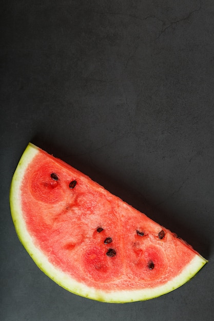 Slices of red watermelon on black