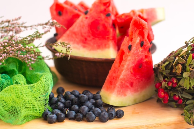 Slices of red watermelon and cranberries Ripe harvest