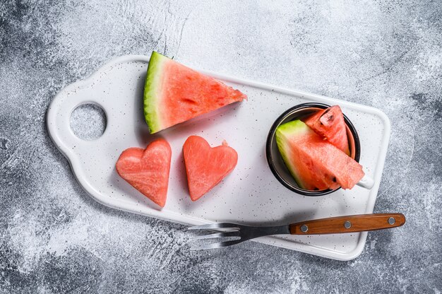 Slices of ripe watermelon in the shape of a heart.