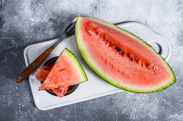 Slices of ripe watermelon on a white cutting Board. 