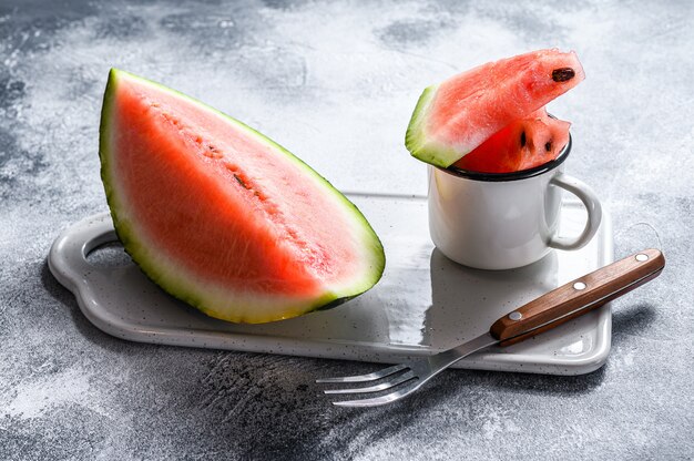 Slices of ripe watermelon on a white cutting Board. 