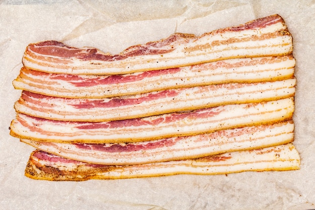 Slices of salted bacon with spices