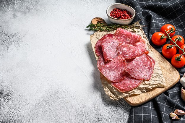 Slices of spanish salami, tomatoes and spices